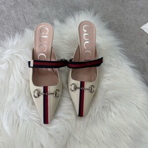 Gucci Cream Mules with Red and Blue Accents.